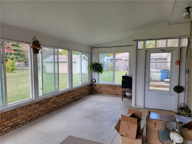 unfurnished sunroom with lofted ceiling and plenty of natural light