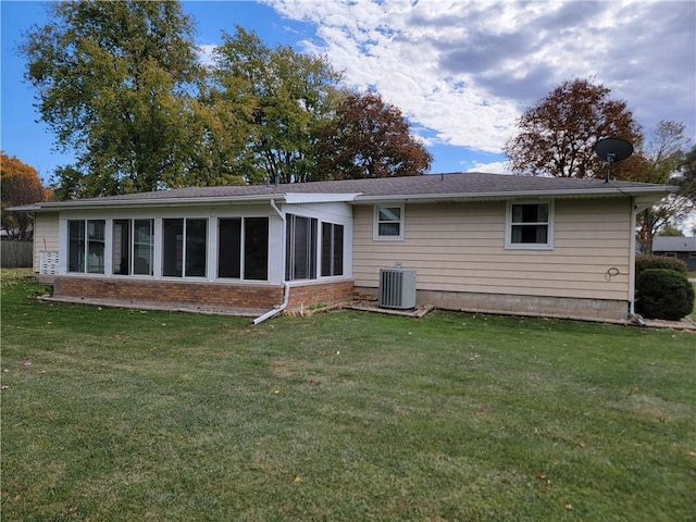 back of property featuring cooling unit and a lawn