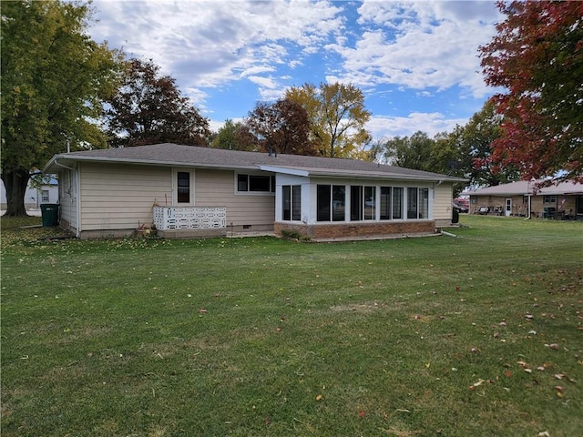 rear view of property featuring a yard