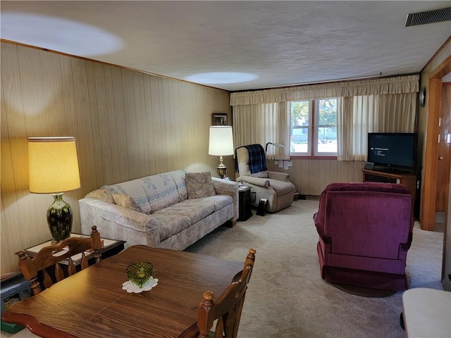 living room featuring light carpet and wood walls