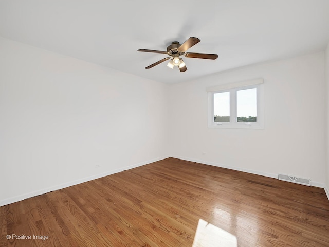 unfurnished room with ceiling fan and hardwood / wood-style floors