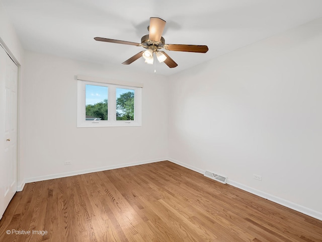 spare room featuring light hardwood / wood-style flooring and ceiling fan