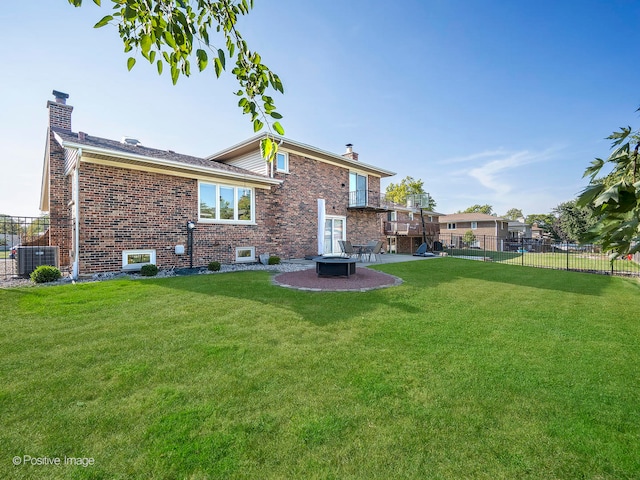 rear view of house featuring a patio area, a yard, and central AC unit