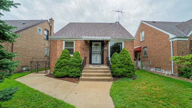 bungalow-style house featuring a front yard