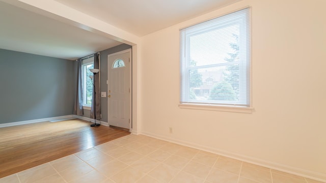 tiled entrance foyer featuring a wealth of natural light