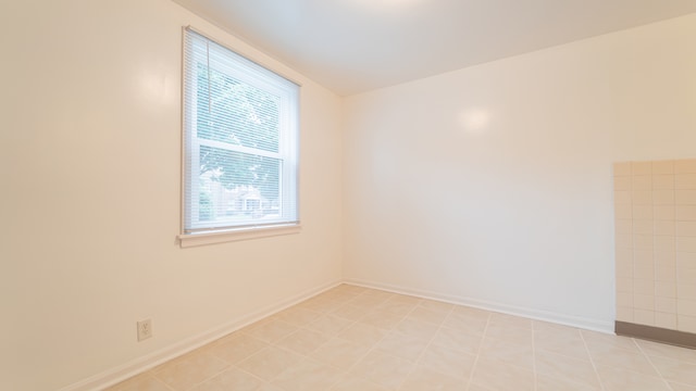 unfurnished room with light tile patterned flooring