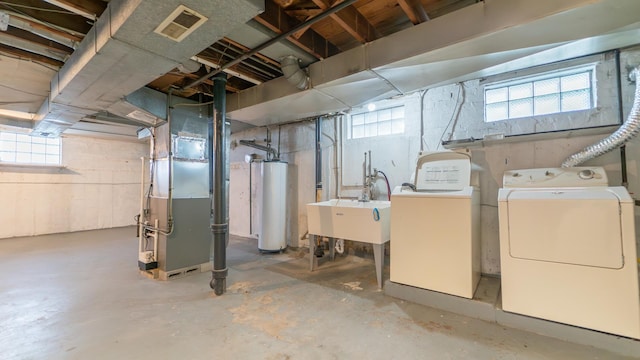 11318 S S Ave J, Chicago, IL 60617 - below grade area with gas water heater, heating unit, washing machine and clothes dryer, and plenty of natural light