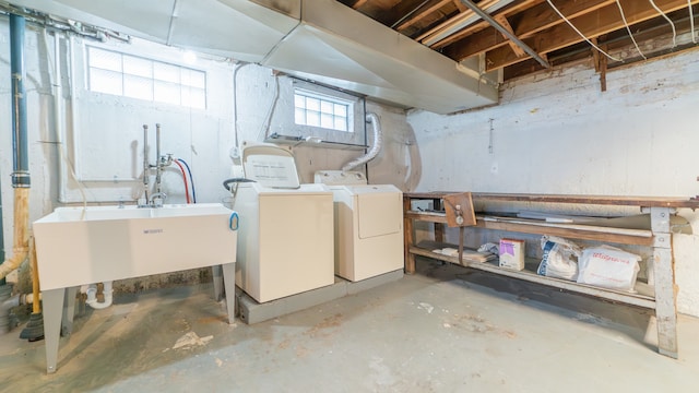 basement with separate washer and dryer and sink