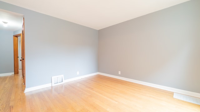 spare room featuring light hardwood / wood-style floors