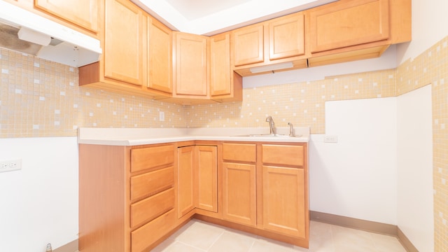 kitchen featuring decorative backsplash, sink, light brown cabinetry, and light tile patterned flooring