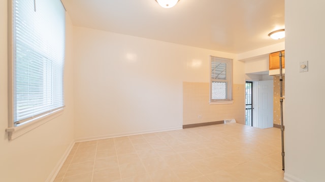 empty room with light tile patterned flooring