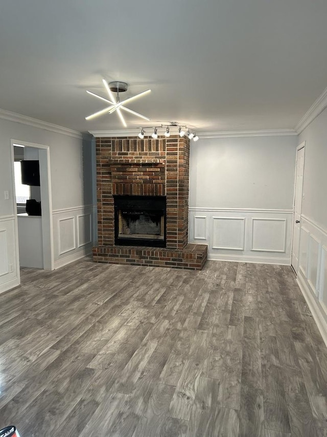 unfurnished living room with crown molding, a fireplace, and hardwood / wood-style flooring