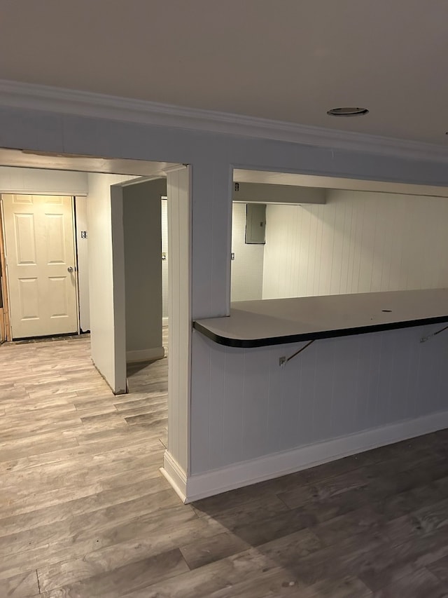 kitchen featuring light hardwood / wood-style floors and ornamental molding