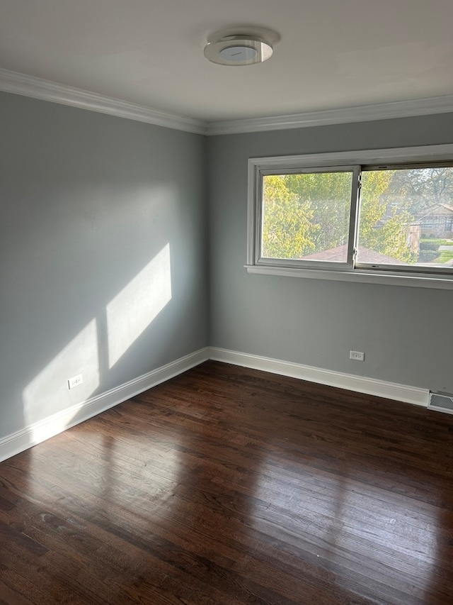 unfurnished room featuring ornamental molding and dark hardwood / wood-style floors