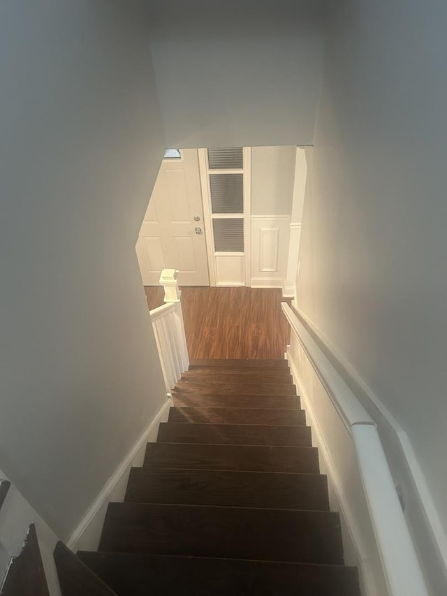 staircase featuring hardwood / wood-style flooring