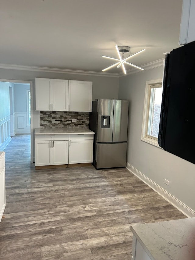 kitchen with white cabinetry, light hardwood / wood-style flooring, and stainless steel refrigerator with ice dispenser