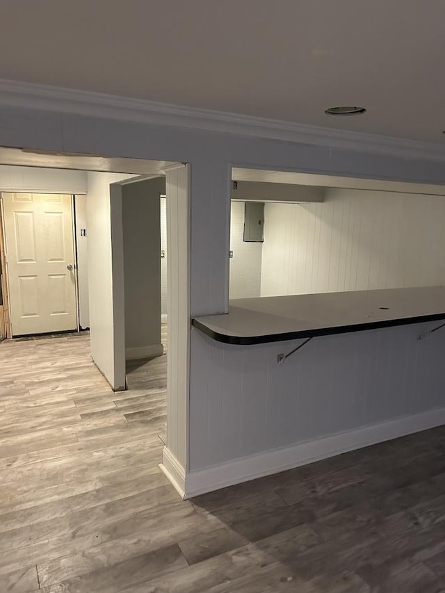 kitchen featuring hardwood / wood-style flooring and ornamental molding