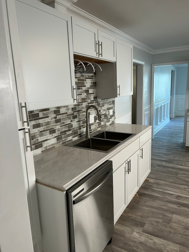 kitchen featuring stainless steel dishwasher, sink, dark wood-type flooring, and white cabinetry