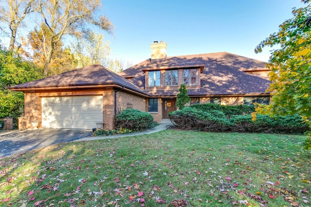 view of front of home with a front yard and a garage