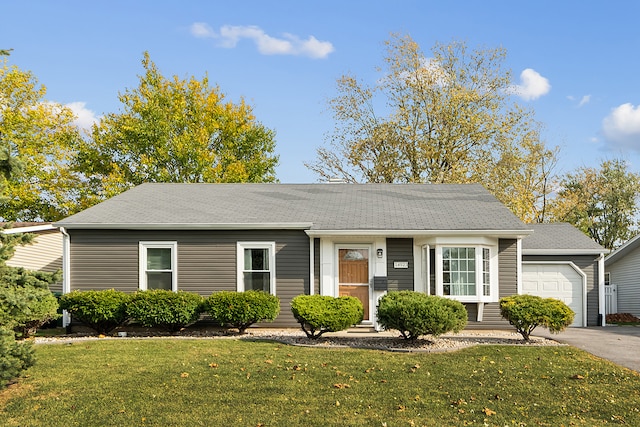 single story home with a front yard and a garage