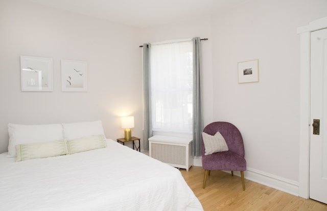 bedroom featuring hardwood / wood-style flooring and multiple windows