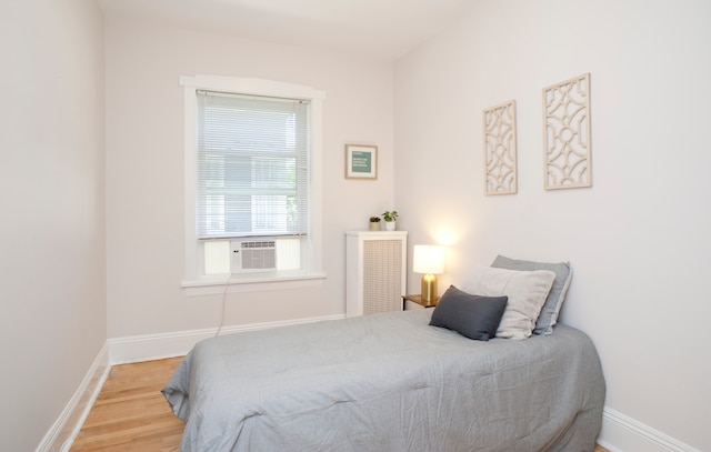 bedroom featuring hardwood / wood-style flooring and cooling unit