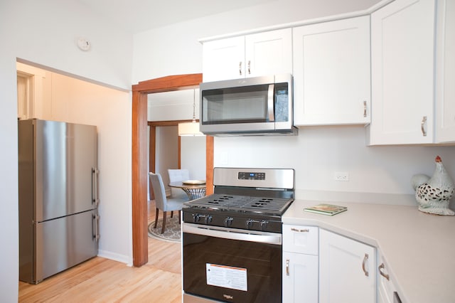 kitchen featuring light hardwood / wood-style flooring, white cabinets, and stainless steel appliances