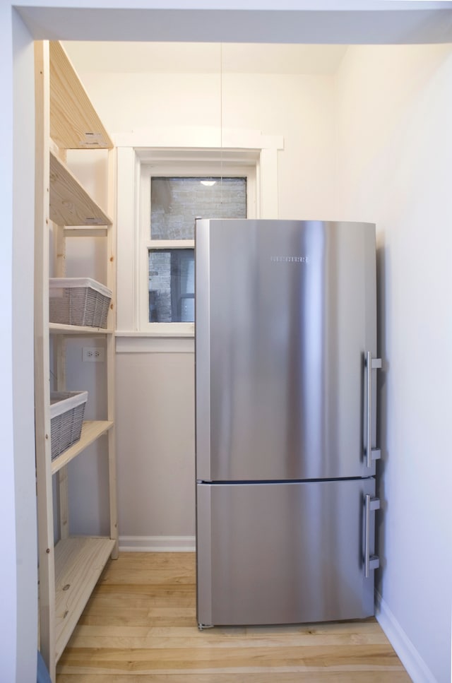 kitchen featuring stainless steel refrigerator and light hardwood / wood-style flooring