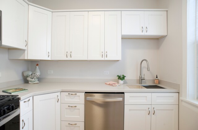 kitchen with white cabinets, sink, and stainless steel appliances