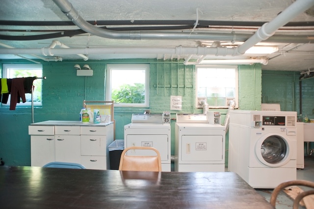 clothes washing area featuring separate washer and dryer