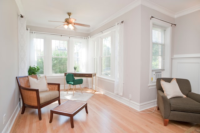 sitting room featuring ceiling fan, ornamental molding, a wealth of natural light, and light hardwood / wood-style flooring