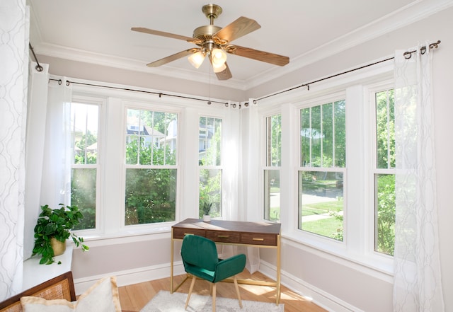 sunroom / solarium featuring plenty of natural light and ceiling fan