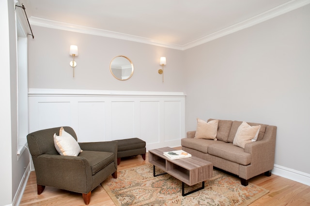 living room with crown molding and light hardwood / wood-style flooring