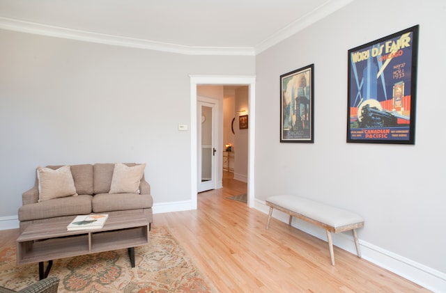 sitting room featuring wood-type flooring and ornamental molding