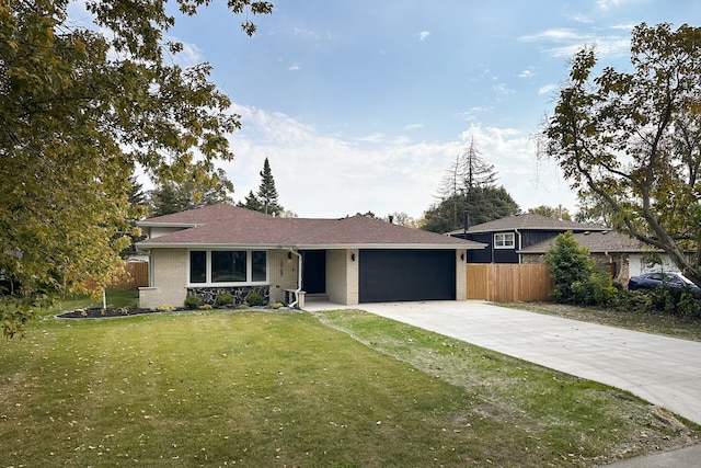 single story home featuring a front yard and a garage