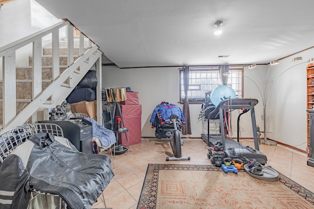 workout area featuring light tile patterned flooring