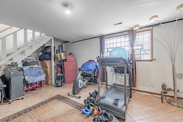 workout room featuring light tile patterned floors