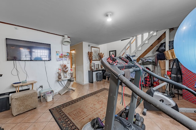 exercise room featuring light tile patterned floors