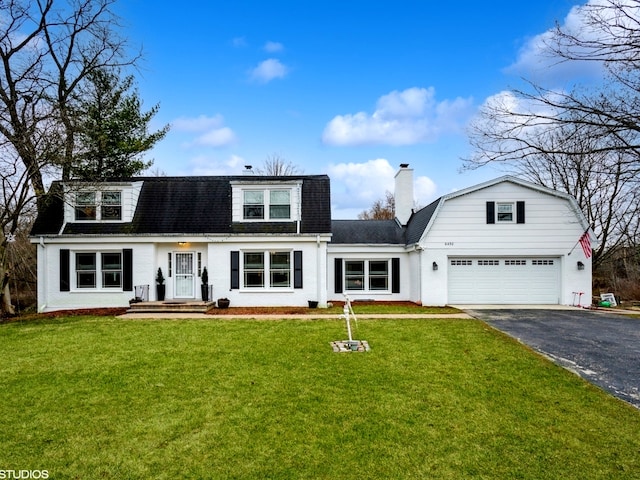 view of front of property with a front lawn and a garage