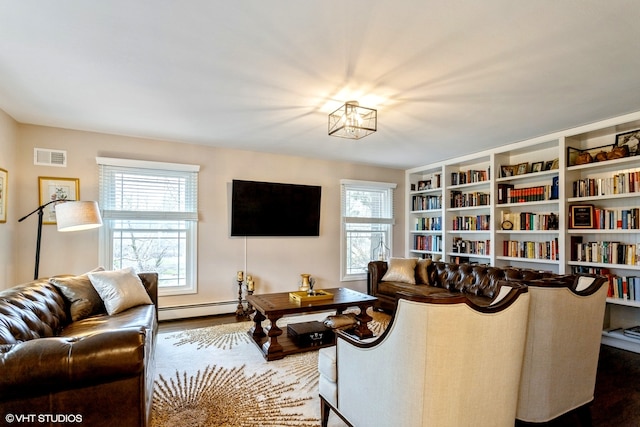 living room with a baseboard radiator and wood-type flooring