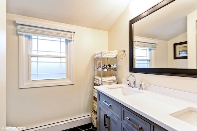 bathroom featuring vanity, lofted ceiling, plenty of natural light, and a baseboard radiator