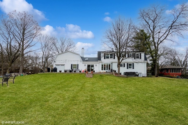 6430 Thurlow St, Willowbrook, IL 60527 - back of property featuring a chimney, a lawn, a gambrel roof, and a garage