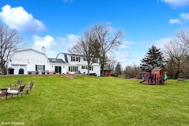 view of yard featuring a playground and a garage