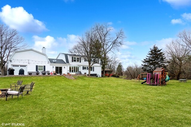 6430 Thurlow St, Willowbrook, IL 60527 - rear view of property featuring a playground, a yard, a chimney, and a gambrel roof