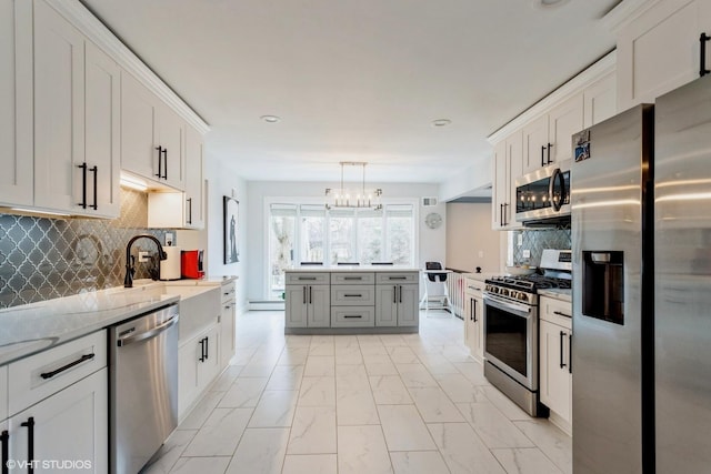 6430 Thurlow St, Willowbrook, IL 60527 - kitchen featuring appliances with stainless steel finishes, a chandelier, light marble finish flooring, backsplash, and white cabinetry