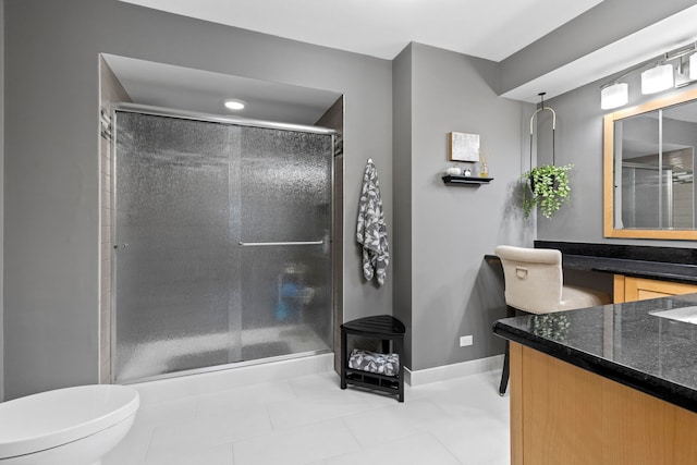 bathroom featuring vanity, an enclosed shower, toilet, and tile patterned floors