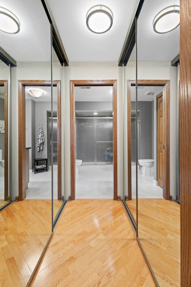 corridor featuring hardwood / wood-style floors