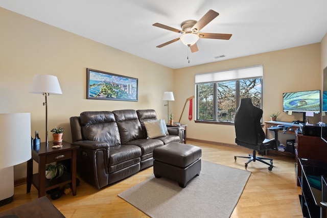 living room featuring light wood-type flooring and ceiling fan