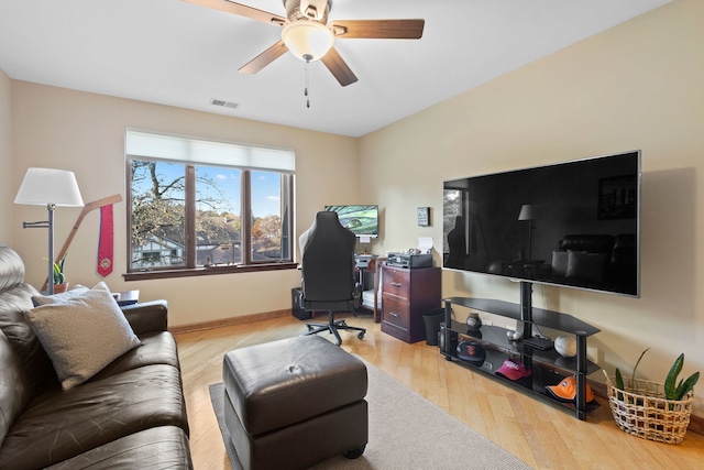 living room with light hardwood / wood-style flooring and ceiling fan