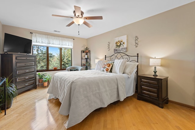 bedroom with light hardwood / wood-style flooring and ceiling fan